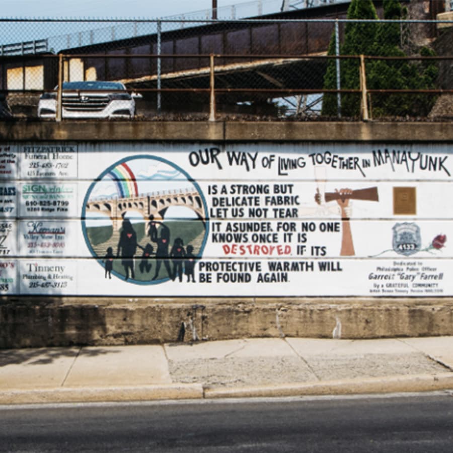 A colorful mural in Manayunk emphasizes the importance of community and unity.