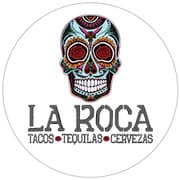 Logo for La Roca featuring a decorative skull and text promoting tacos, tequilas, and cervezas.