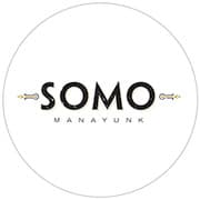 Logo for SOMO Manayunk, featuring bold black text with decorative elements.