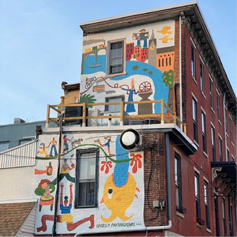 Colorful mural depicting various figures and scenes on a building exterior.