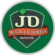 Logo of JD McGillicuddy's featuring a green shield and a shamrock.